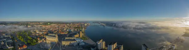 Photo of Panoramic aerial view of Aalborg city with House of Music and Aalborg port in the early morning with fog, Denmark