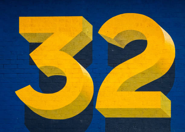 istock Big bright yellow three dimensional number thirty two on blue background. 1327235035