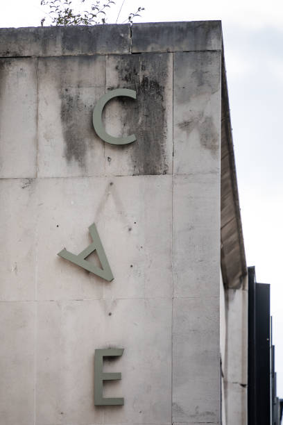 istock Letter A falling down hanging from side of derelict abandoned old 1970's concrete building. Sign dropping off wall. 1327235099