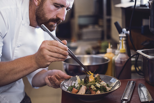 Preparing food in commercial kitchen.