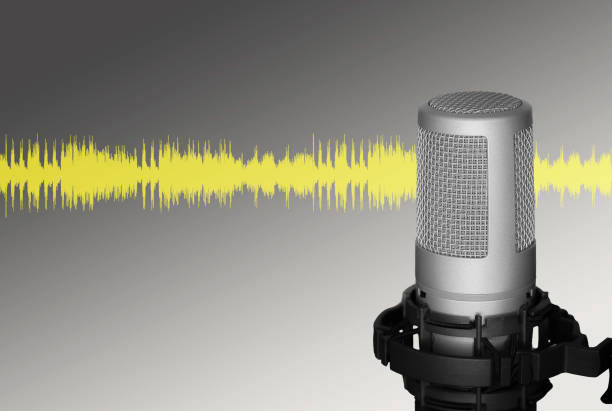 Professional microphone against yellow waveform in grey background, usable for banner, podcast or recording studio. Copyspace