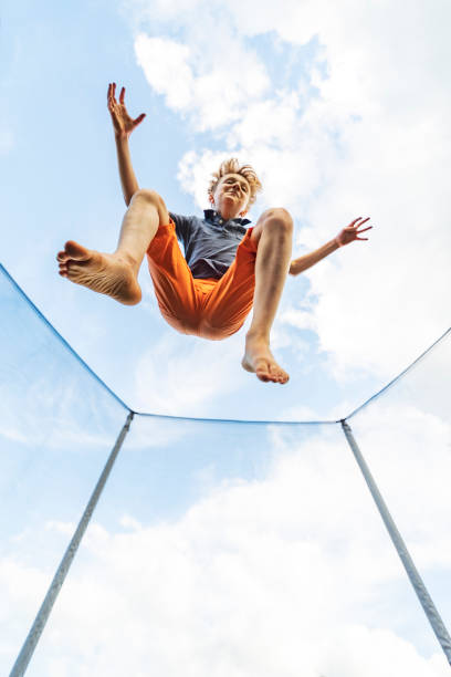istock Little boy jumping on the trampoline 1327237131