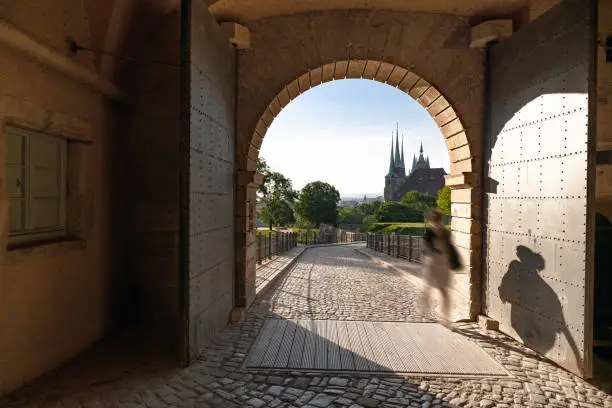 view through the stone gate of Petersberg on the historic catherdral in the background