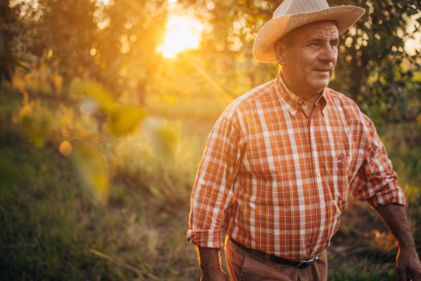 istock Farmers walking through the orchard 1327238524