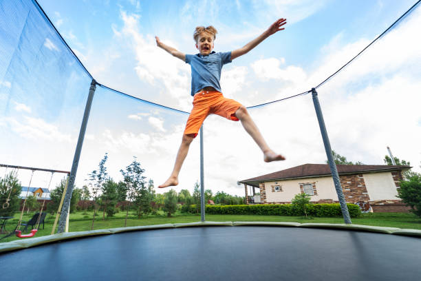 Young man doing a somersault on the background of blue sky