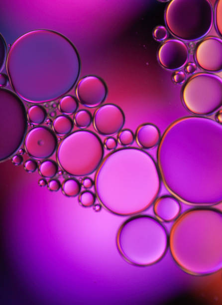istock Abstract oil droplets on water creative art image and pattern on purple background, 1327239076