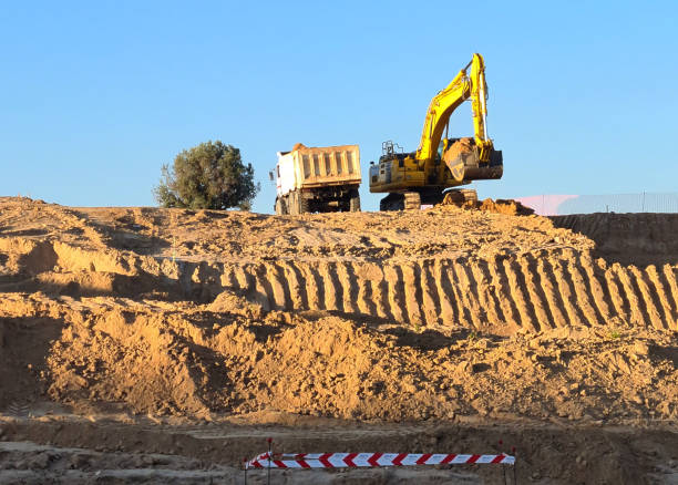 istock Excavator machine filling truck in construction site on sky background. 1327247694