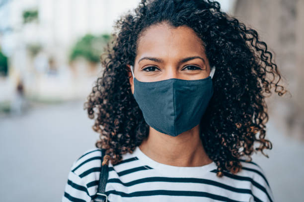 istock Woman with protective face mask outdoors. 1327248645
