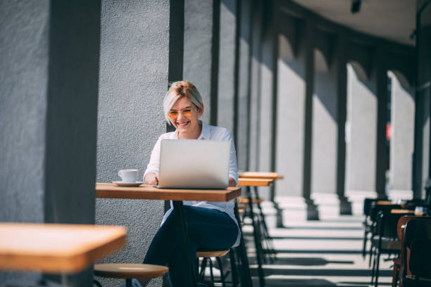istock Young woman drinking coffee and checking email 1327249909