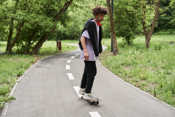 istock Man riding a board while enjoying extreme sport in urban park settings 1327252078