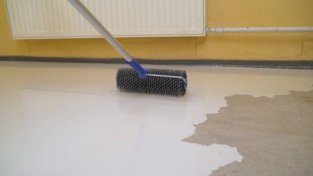 istock finishing work - the worker does the bulk floor. Needle roller for bulk floors 1327252225