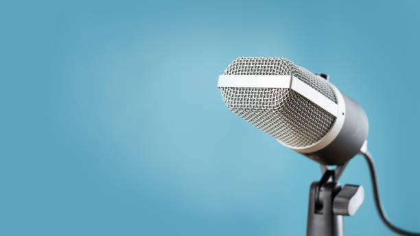 istock microphone for audio record or Podcast concept, single microphone on soft blue background  with copy space 1327252559