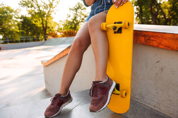 istock Young woman outdoors with skateboard. 1327253383