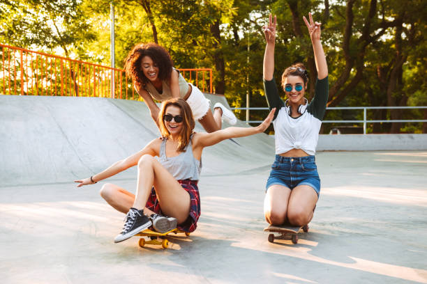 istock Three excited young girls with skateboards 1327253536