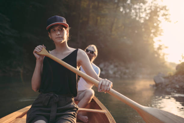 istock Woman paddling canoe on a forest lake 1327254073
