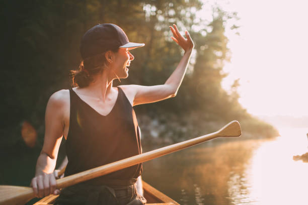istock Woman paddling canoe on a forest lake 1327254173