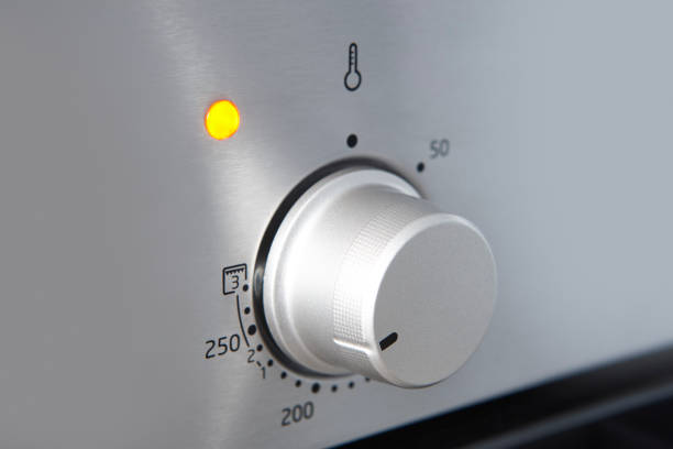 Oven cooking temperature control knob. Kitchen equipment panel detail