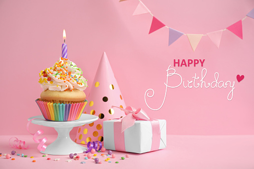 Happy Birthday! Composition with delicious cupcake on pink background