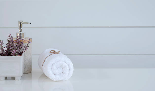 istock Roll of clean spa towels on white table with copy space. 1327255300