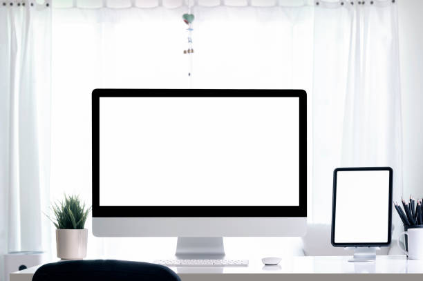 istock Creative workspace with blank white screen computer monitor and tablet on white wooden table. 1327255495