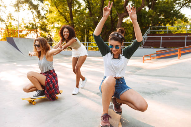 istock Three positive young girls with skateboards 1327255951