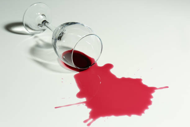 istock Overturned glass and spilled wine on white background 1327256907
