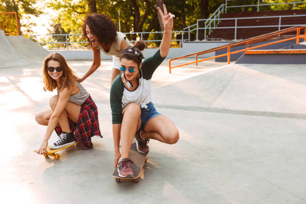 istock Three cheerful young girls with skateboards 1327257091