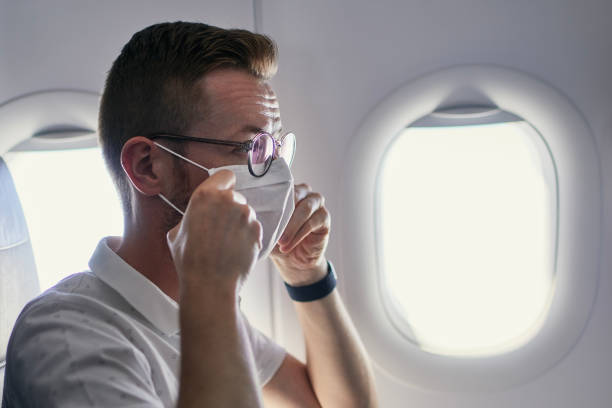istock Passenger wearing protective face mask in airplane