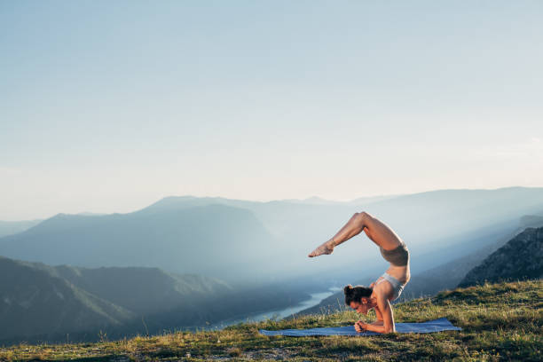 istock Fit young girl practicing yoga at sunset 1327257285