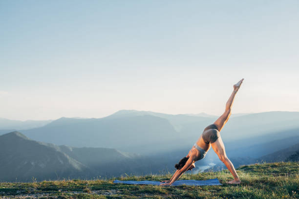 istock Fit young girl practicing yoga at sunset 1327257290