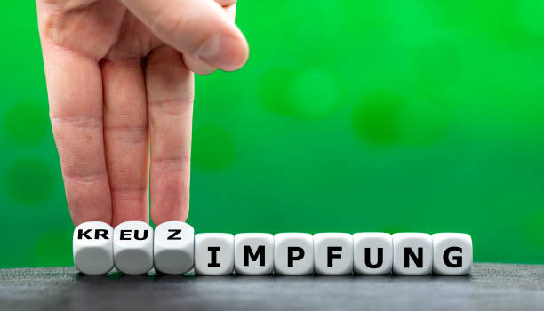 istock Symbol for a vaccination against covid 19 with two different vaccines. Dice form the German expression 