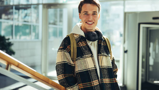 istock Young man standing at college 1327261858
