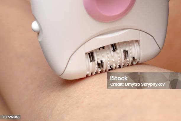 Skin Care And Health Hair Removal Woman Epilating Leg White Electric Epilator Stock Photo - Download Image Now