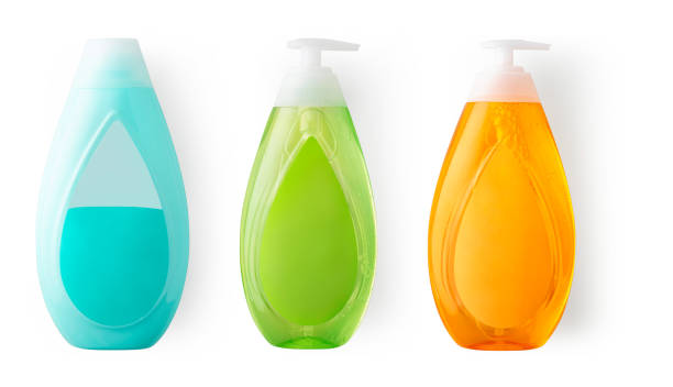 Close-up of soap and shampoo bottles in 3 different colors. Soap on the front and shampoo skewers on the back. Photographed in white background and in the studio.