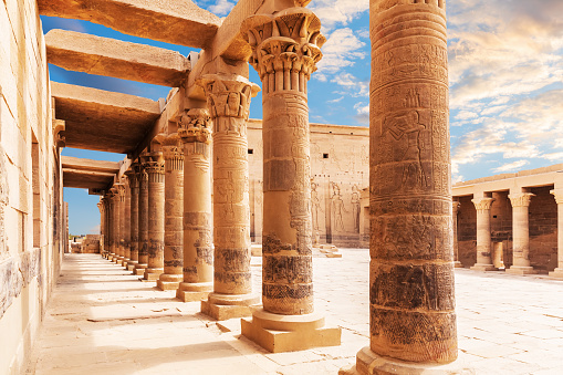 Low angle view looking up at the hieroglyphs on pillars of The Great Hypostyle Hall of the ancient Temple of Karnak at Luxor.