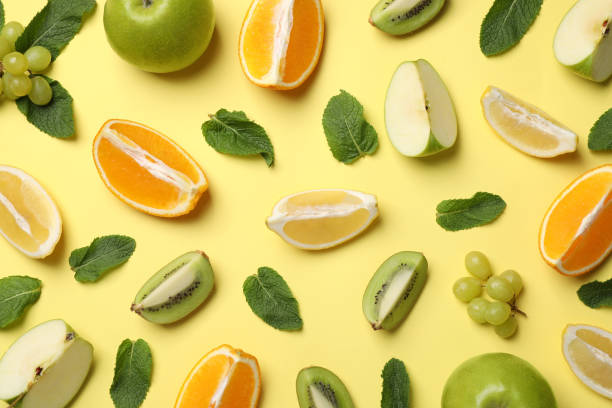 istock Different fresh ripe fruits and mint on yellow background, flat lay 1327266913