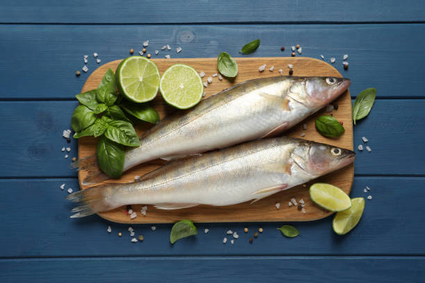 istock Fresh raw pike perches and ingredients on blue wooden table, flat lay. River fish 1327266914