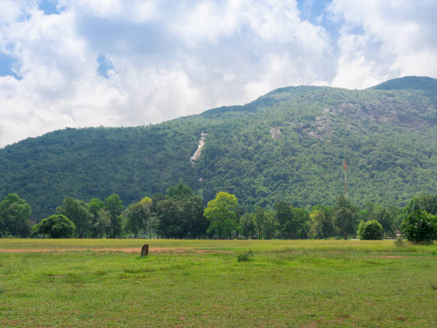 istock mountain with green grass field and cloudy sky 1327266921