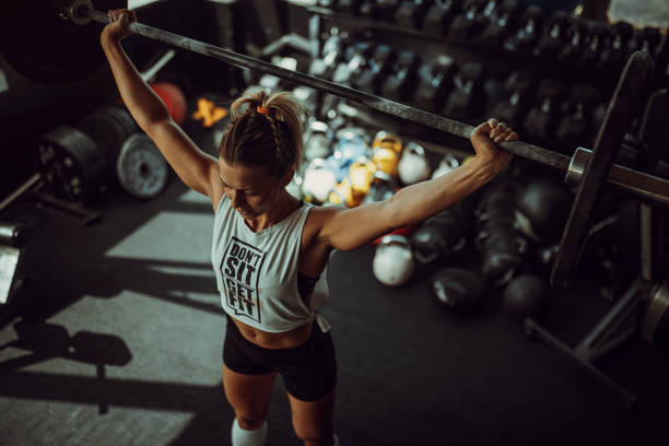 istock Fit woman weightlifting in gym 1327269549