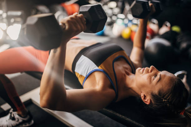 istock Fit woman exercises with dumbbells 1327271120