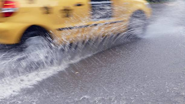 istock Cars go through a deep puddle on the street 1327272416