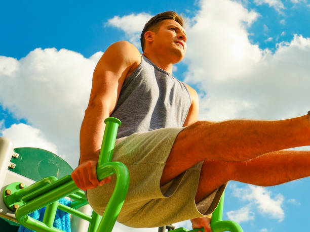 istock Man doing legs exercises in outdoor gym 1327273356