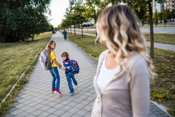 Mom watches her children go to school