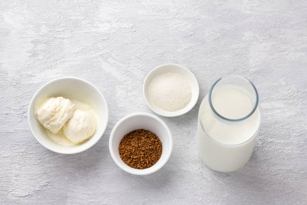 istock Ingredients for dalgona coffee. Instant coffee, milk, ice cream and sugar. Light gray textured background 1327273734