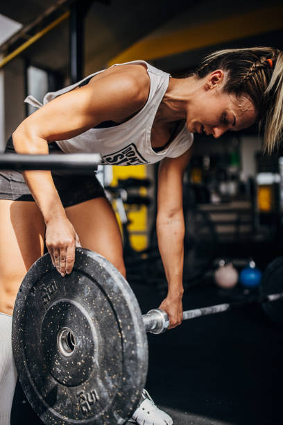 istock Fit woman preparing weights for training 1327274767