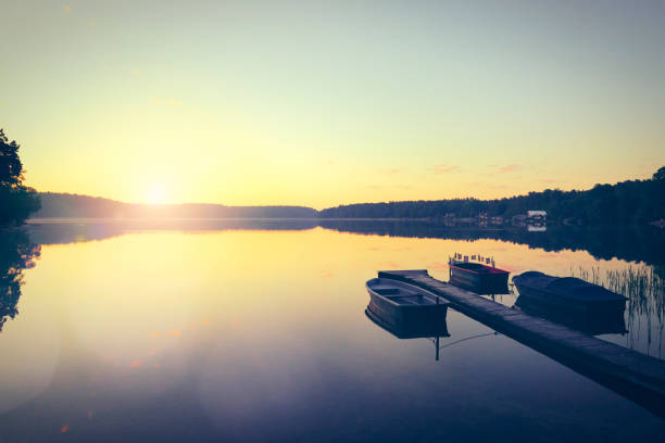 istock Beautiful sunrise on the lake with boat 1327274977