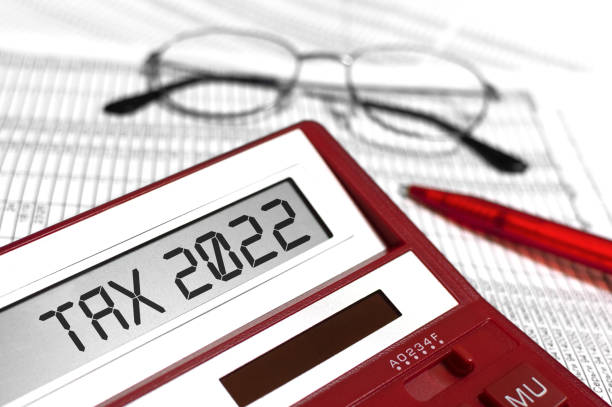 word tax 2022 on calculator. glasses, pen and the calculator on documents. the concept of financial stability, income statement. - tax tax form financial advisor calculator imagens e fotografias de stock