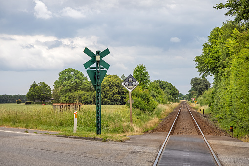 Single track railroad crossing a road in Lolland which is an remote part of Denmark. It is one of the few places in Denmark where railroads and roads are crossing each other whit out bridges