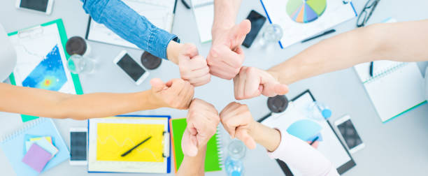 istock The students thumb up at the table. view from above 1327276923