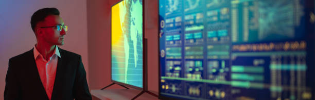istock The businessman standing near screens with graphs 1327277540